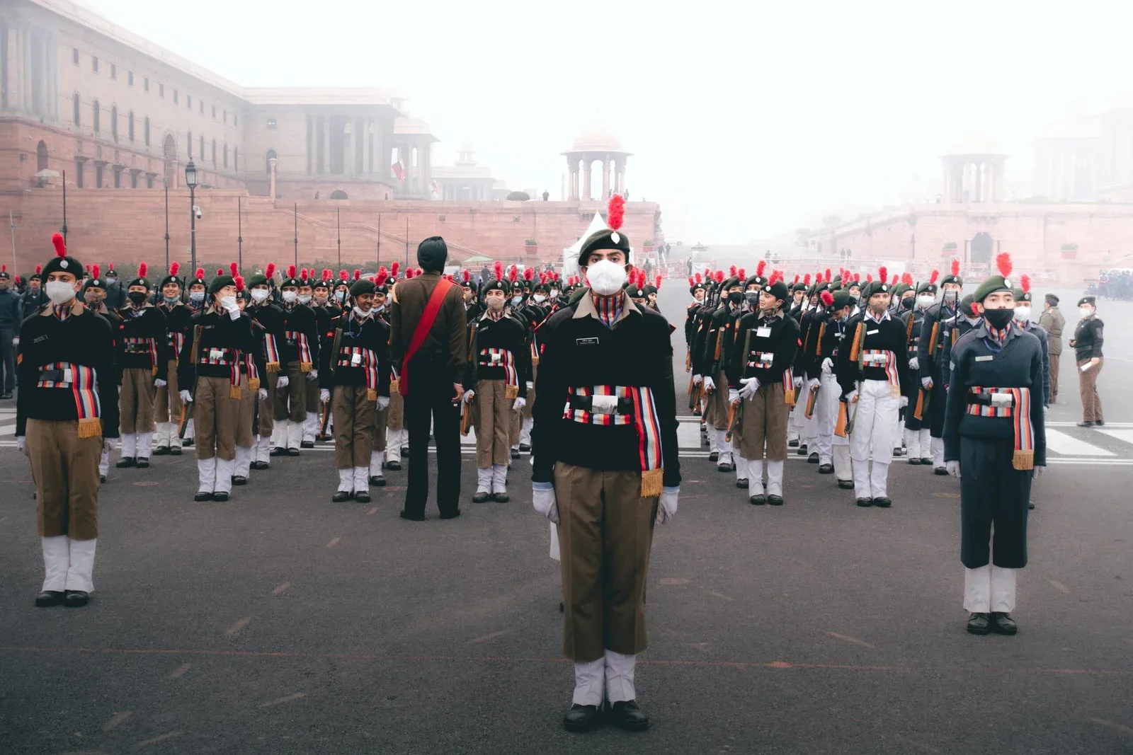 Uniformed trainees standing in formation on a parade ground